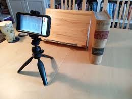 phone stand placed at edge of desk for filming